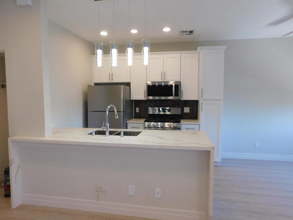 WOW! LUXURIOUS 2 bedroom, 2 bath has been completely remodeled from top to bottom! No expense has been spared in this stunning unit! You'll be impressed with the gourmet kitchen! Sleek quartz kitchen countertops pleases the eye! Top of the line stainless steel appliances includes a 5 burner GAS stove, dishwasher, Microwave, + the Refrigerator is included! You will love the soft close Shaker style cabinets and drawers! High quality gage stainless steel sink with grates, stylish faucet, modern hanging light fixtures, glass backsplash and more! Wait until you see the bathrooms! The Micro Glaze, dual flush toilets are super easy to clean! High end glass shower doors open to your 2 lavish showers and tub. Waterproof flooring and baseboards throughout! NO carpets that cause allergies! Both bedrooms have mirrored closet doors. Must have INDOOR, large capacity Washer/Dryer! Even the HVAC system is new!Relax in your balcony and enjoy the evening sunsets and cool breezes! Community Pool nearby. Centrally located in Thousand Oaks, close to freeways, Civic Arts Plaza, The Lakes, Gardens of the World, Oaks Mall and favorite grocery stores! Don't lose out on this highly upgraded 2 +2 on the 2nd floor with a view!