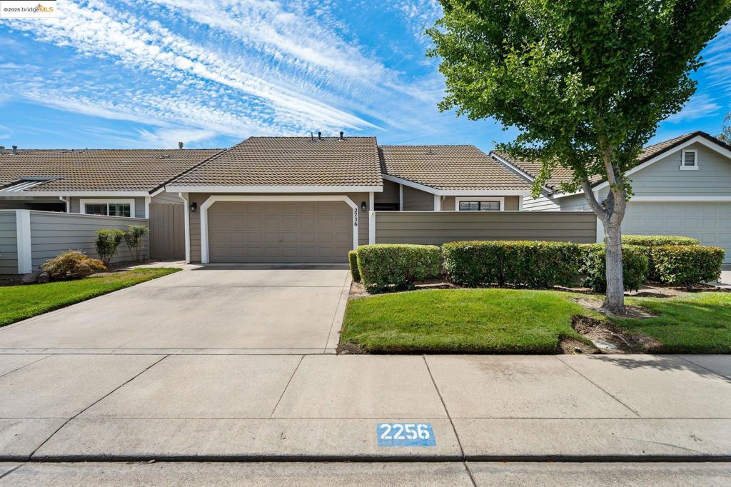 Discover style and comfort in this beautifully updated 2 bed, 2 bath single-story home in desirable Camborne Dr. With 1,220 sq ft of light-filled living space and vaulted ceilings, this home lives large. Enjoy a modern kitchen with quartz countertops, subway tile backsplash, stainless steel appliances, and bar seating — all opening to the living and dining areas. A cozy brick fireplace and custom built-ins add charm. The spacious primary features vaulted ceilings, dual closets, and a refreshed ensuite. Outside, relax in the private courtyard with a pergola, concrete patio, and garden beds — ideal for entertaining. Additional perks include a garage fridge (included), negotiable washer/dryer, central HVAC, and low-maintenance landscaping. Conveniently located near shopping, dining, and freeway access, this turnkey gem is a perfect fit for comfort, style, and function.