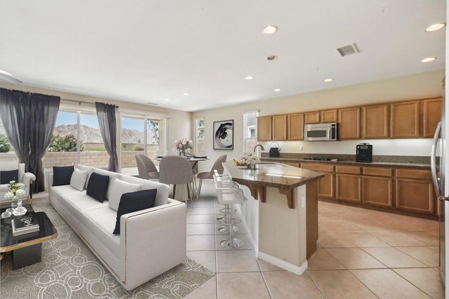 On the Golf Course with Mountain Views!!!! Presenting the highly sought-after Monterey floor plan, this beautifully appointed single-family residence is ideally situated adjacent to the 8th tee box of The Golf Club at La Quinta. Offering 1,693 square feet of refined living space, the home features 2 bedrooms, 2 bathrooms, and a versatile den/office that can serve as a third bedroom. The open-concept great room is enhanced by tile flooring, recessed lighting, a media niche, custom window treatments, and an abundance of natural light. The chef's kitchen is equipped with stainless steel appliances, built-in double ovens, a gas cooktop, microwave, dishwasher, newer refrigerator, pantry, and a prep island with bar seating. The spacious primary suite includes a bay window, en suite bath with dual vanities, large shower enclosure, and a generous walk-in closet. The guest bedroom offers privacy and access to a nearby full bath. Additional highlights include an interior laundry room with newer washer/dryer included, extensive cabinetry and utility sink, a covered patio with awning, and a backyard putting green perfect for entertaining or practicing your short game--all set against the vibrant backdrop of a scenic No. 8, par-3 hole.