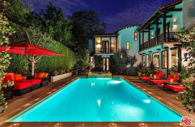 Emotional Spanish hideaway located above the Sunset Strip. Rare and fully gated, street-to-street lot enveloped in mature landscaping with the utmost in privacy. True resort style living with thoughtful Balinese influences throughout. Featuring perfectly executed floor plan with high ceilings, stone and wood floors and French doors that open to the tranquil grounds. Main level includes the living room, dining room, one en-suite guest bedroom plus an open kitchen and family room with pitched, beamed ceiling. The second level offers three en-suite bedrooms plus the master suite with fireplace, terrace, spa bath and walk-in closet. A hidden entry leads to a lower level rock cave wine cellar with approx. 1,500 bottle capacity, cigar room and humidor. The magical grounds offer the perfect respite to enjoy small or large gatherings around the pool, dining area complete with built-in BBQ, or in the outdoor theater. An outdoor guest house and additional gated parking is perfect for guests.