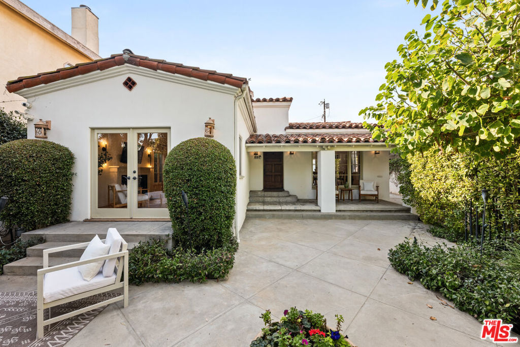 Nestled behind private gates in the heart of Beverly Grove, this charming Spanish-style retreat blends timeless charm with modern elegance. A private courtyard greets you upon entering the property. Step through the front door into a welcoming living room, where a cozy fireplace and French doors invite you to unwind or seamlessly transition to the serene front patio--perfect for alfresco gatherings. The formal dining room, flooded with natural light, flows effortlessly into a designer chef's kitchen, featuring custom teak cabinetry, pristine marble countertops, and premium Viking appliances. The spacious primary suite serves as a personal escape, complete with a generous closet, a spa-inspired marble bathroom, and direct access to the backyard. Additional features include an integrated surround sound, and a security system for added peace of mind. Ideally located in one of LA's most sought-after neighborhoods, this home offers unbeatable access to Robertson Blvd's renowned boutiques and eateries, the Beverly Center, Cedars-Sinai, Beverly Hills, and Melrose Avenue. A true sanctuary that effortlessly combines style, comfort, and convenience.