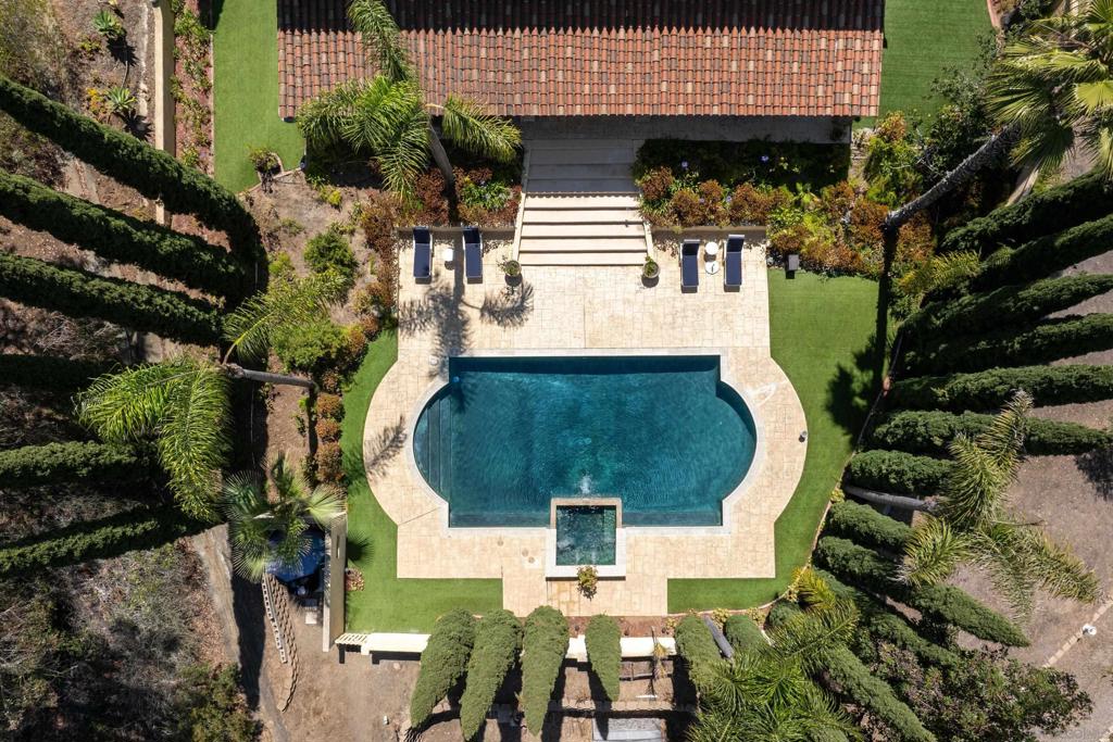 Discover refined living behind the gates of South Pointe Farms, one of Rancho Santa Fe’s most prestigious and serene communities. This expansive ~9,800 sq ft estate on 3 beautifully landscaped acres offers exceptional space, comfort, and privacy. Featuring 6 bedrooms and 7 bathrooms, all with en-suite baths, the home is designed for gracious living and entertaining. Enjoy a dramatic 28-foot grand entry, generous formal and informal living spaces, and attached guest or staff quarters with a separate entrance. Outdoor amenities abound: a heated saltwater pool for year-round enjoyment, a tennis and pickleball court, zoning for up to three horses, and a secondary driveway for added convenience. Owned solar with 48 panels enhances energy efficiency. Ideally situated in a great West Rancho Santa Fe location within the coveted Olivenhain Pioneer Elementary School District, this home offers easy access to Rancho Santa Fe Village, top-rated schools, shopping, dining, golf, and the coast—perfect for those seeking the ultimate in comfort, privacy, and the exceptional Southern California lifestyle.