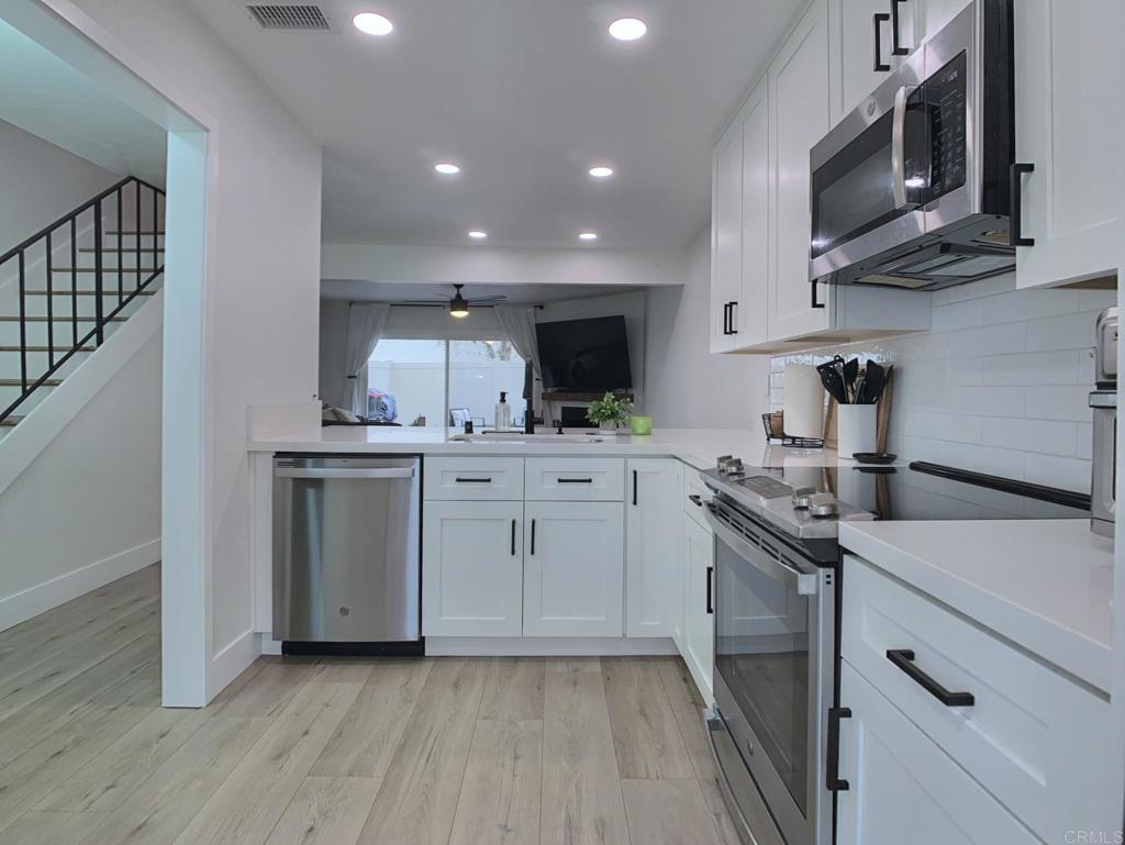 Gorgeous two-story end-unit townhome in Santee!, This one has it all! Lovingly remodeled over the last two years, including, kitchen cabinets, quartz kitchen countertops, stainless appliances, vinyl plank flooring, vinyl windows, lighting, ceiling fans, fireplace mantel and tile, bathroom vanities and tile shower, smart thermostat…must see, too many upgrades to list! Home includes central HVAC, full size laundry closet, and individual water heater. Two upstairs bedrooms with a full bath and a half bath downstairs. This home has just one shared wall, a private, pet friendly patio with upgraded vinyl fencing which flows off the living room and a balcony off the primary bedroom. The property includes one reserved, covered parking space and extra open space parking. Located near Santee Lakes, Carlton Oaks, Mast Park and San Diego River Trails. Easy access to Highway 52, beaches and downtown SD. VA Ok!