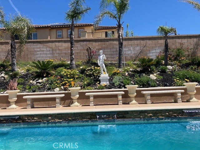 Low $ per sq. ft. Appraised at $1,675,000 shown in pictures to view. One of the largest floor plans in the community, this home offers a rare opportunity for those who value open space, comfort, & a well-rounded lifestyle.
Executive 4-bedroom, 4.5-bathroom home offers 4,610 sq. ft. of spaciously designed living space in the gated community of Rancho Etiwanda Estates, located at top of Day Creek. Set on a quiet cul-de-sac, this south-facing property features sweeping snow capped mountain & city views, along with unique design elements like arches & spiral wrought iron staircase overlooking large 2-story formal living room. inspired by feng shui principles. The open-concept layout balances style & privacy, making it ideal for both daily living & entertaining.
On the main level, you will find a private bedroom with in-suite bath with a separate entrance, perfect for multi-generational living or guests. A separate den provides flexible space for a home office, study, or playroom. The gourmet kitchen includes built-in stainless steel appliances, a built-in refrigerator, granite countertops, a large center island, & a walk-in pantry. The home also features a formal dining room, casual eat-in area, & family room with fireplace.
Upstairs, the primary suite includes a bedroom, full bath with dual vanities, a Jacuzzi tub, walk-in shower, oversized walk-in closet, and an adjoining area for office, sitting room, exercise room, or nursery. A spacious loft offers options for a game room, media space, or second living area. No Jack & Jill bathrooms, each bedroom includes its own in-suite bathroom, providing comfort & privacy throughout the home. Also located upstairs is a big separate laundry room, complete with ample storage cabinets and a utility sink, providing practical convenience for a busy household.
European inspired backyard with sparkling pool, waterfalls, statues, benches, covered patio, dual trellis covers, landscaped grounds, automatic sprinklers, & a grassy side yard all designed with both relaxation & ease of maintenance in mind. This home is part of a gated community with a security patrol, offering peace of mind just minutes from Etiwanda Preserve hiking trails, top-rated Etiwanda schools, & Victoria Gardens, one of the area’s premier destinations for shopping, dining, & entertainment.
Rancho Cucamonga recognized in 2020 as 10 All-America City.
Furniture can be included. Owner is RE broker.