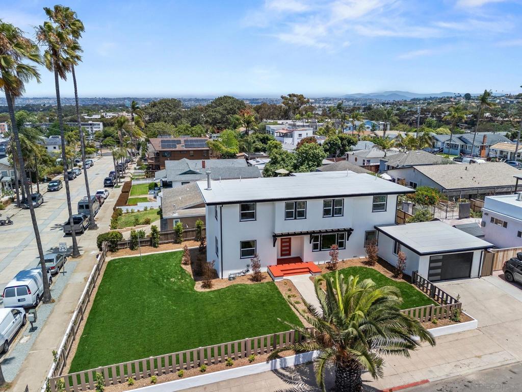 Timeless Coastal Elegance with Historic Provenance in the Heart of Ocean Beach, come view this masterfully reimagined estate where timeless charm meets modern luxury. This fully renovated Ocean Beach residence is more than a home; it is a landmark of historic provenance, thoughtfully restored with uncompromising attention to detail and an eye for elevated living. Step inside to discover a sophisticated blend of classic design and contemporary comfort. From handcrafted custom cabinetry in the chef’s kitchen to expansive light-filled living spaces, every inch of this grand residence reflects refined craftsmanship and impeccable taste. Panoramic views of the Pacific Ocean and nightly SeaWorld fireworks offer a daily backdrop of natural beauty and coastal vibrancy. Outdoors, a sprawling, park-like yard awaits — framed by a brand-new privacy fence and professionally designed landscaping. This exceptional outdoor retreat provides the perfect setting for elegant entertaining, tranquil relaxation, or enjoying San Diego’s year-round sunshine in total seclusion. Ideally located just steps from Ocean Beach’s vibrant core, this rare offering places you within effortless reach of beloved local shops, award-winning cafes, the farmers market, and the beach itself — all while nestled in a serene residential enclave rich with character and community history. A treasured piece of Ocean Beach’s story, beautifully brought back to life and ready to inspire the next chapter. Don’t miss this rare opportunity to own a one-of-a-kind coastal sanctuary with size, style, history, and soul.