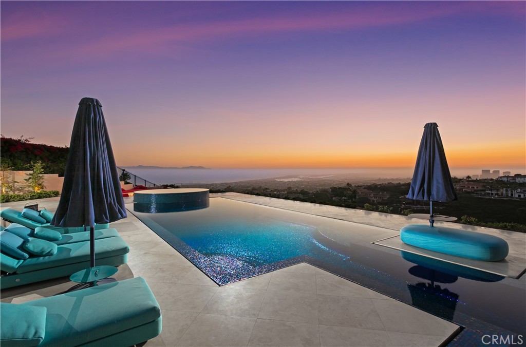A true timeless masterpiece sited on a front-row, premier view lot designed to maximize dramatic harbor, ocean, and Catalina Island vistas, 9 Pelican Crest Drive redefines coastal luxury with a rare blend of sophisticated design, state-of-the-art technology, and resort-style amenities. Spanning approximately 11,400 square feet of refined interiors and set on an expansive 32,904-square-foot parcel, this estate was newly renovated in 2025 to meet the highest standard of modern elegance. Masterfully appointed and fully furnished with iconic pieces from Europe’s most renowned design houses—including Giorgetti, Poltrona Frau, Edra, Fendi Casa, Hermès, Minotti, Maxalto, and Poliform—the home is a true showcase of global refinement. Custom Barovier & Toso chandeliers from Murano, Italy, illuminate the interiors, casting a warm, inviting vibrancy throughout the living spaces. Designed to inspire both grand-scale entertaining and elevated daily living, the home features a new 12-seat private theater with custom leather seating and cutting-edge audiovisual systems, a dedicated playroom anchored by a 14-foot LED video wall, and a private gym with a transparent 75” mirror TV. A private elevator services all levels of the residence, offering seamless convenience throughout. Expansive formal and casual living areas open to ocean-facing terraces, creating a flawless flow between indoor and outdoor living. Outdoors, newly designed landscaping frames the home’s commanding views, while vibrant furnishings by Paola Lenti elevate every exterior space with contemporary elegance. A brand-new infinity-edge pool finished in shimmering glass tile serves as the estate’s centerpiece, offering a stunning visual and sensory experience. A full smart home system and top-tier security infrastructure complete this one-of-a-kind offering—delivering the pinnacle of style, innovation, and peace of mind in one of Southern California’s most coveted ocean-view communities.