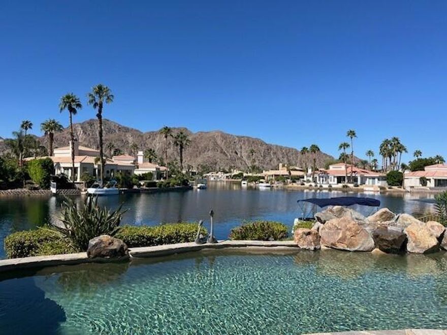 Welcome to your dream retreat in the heart of La Quinta, where luxury meets serenity. This beautifully refreshed lakefront estate offers unobstructed panoramic views of the majestic Santa Rosa Mountains and a breathtaking 27-acre private lake. Whether you are entertaining guests or enjoying a peaceful morning coffee, the setting is nothing short of spectacular. Step inside to discover a light and bright interior featuring a spacious great room floor plan, soaring vaulted ceilings, and elegant finishes throughout. The gourmet kitchen, formal dining area and a swanky bar with arguably the best views on the lake, make entertaining a breeze. The Primary Suite is a true sanctuary, offering two closets, vaulted ceilings, stunning lake views, private slider access to the patio, and a spa-like bath with dual vanities, soaking tub, and separate shower. Recent updates include fresh paint and designer lighting throughout, creating a crisp, modern feel. Step outside and take full advantage of the desert lifestyle with a private pool and spa, perfect for relaxing or entertaining. Fire up the built-in outdoor BBQ and dine alfresco while taking in the breathtaking views. And for the ultimate lakefront experience, enjoy your private dock and electric Duffy boat--ideal for sunset cruises or peaceful mornings on the water. Residents also enjoy access to resort-style community amenities, including pickleball, tennis, and a sparkling community pool. All this, just minutes from world-class golf, fine dining, shopping, and the very best the Desert has to offer.