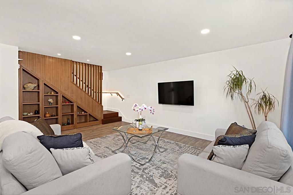 Beautifully updated townhome in Genesee Highlands with nearly every detail upgraded. The open floor plan features a spacious living and dining area flowing into a modern kitchen with custom tile, soft-close drawers, and recessed lighting. Flooring includes bamboo wood upstairs, laminate planks downstairs, and a striking custom ipe wood lighted staircase. A standout feature of the home is the custom walnut under-stair storage and display system, designed by a master cabinet maker with premium German slides—blending elegance with functionality. All three bedrooms include built-in closets and ceiling fans, with the primary bedroom offering a walk-in closet complete with a custom organizer. Additional highlights include solar panels, outdoor patio, shared garage, and abundant storage throughout. Community amenities include parks, playgrounds, pool, and outdoor recreation areas. Ideal location close to UTC shopping, UCSD, and top-rated schools.