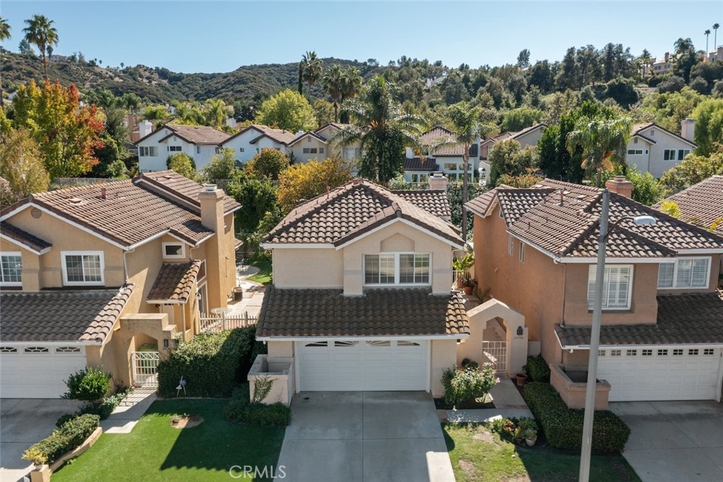 NESTLED IN THE HILLS ON A FLAT CULDESAC STREET IN THE EVER POPULAR GUARD GATED NEIGHBORHOOD OF CALABASAS HILLS. NEARBY IS THE AWARD-WINNING LAS VIRGENES ELEMENTARY SCHOOL BAY LAUREL, A PLAY PARK, AND TWO RESORT STYLED HOA POOL GROUNDS. GATED COURTYARD ENTRY. WHITE ON WHITE KITCHEN, TILED COUNTERTOPS, DINING AREA OPENS TO OUTDOOR TRELLIS COVERED PATIO. WALLS OF WINDOWS. FIREPLACE IN LIVING ROOM. WOOD AND TILED FLOORS. ENSUITE BATHROOM IN MASTER, MASTER WITH PITCHED CEILINGS AND WALK-IN CLOSET. SECONDARY BEDROOMS SHARE THE HALLWAY BATHROOM. GRASSY YARD WITH TRELLIS COVERED PATIO. CALABASAS OFFERS A PRIVATE MEMBERS ONLY COUNTRY CLUB WITH GOLF COURSE, THE COMMONS, AN ENTERTAINING DINING AND SHOPPING, OLD TOWN FARMER'S MARKET ON SATURDAY'S, CALABASAS CITY OWNED TENNIS AND SWIM CLUB, A RESIDENT'S ONLY LAKE (Additional fee)  HIKING AND BIKING, AND MORE.