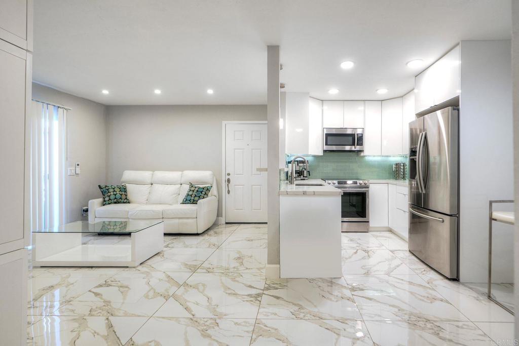 Every detail has been thoughtfully upgraded, making this immaculate unit truly stand out. The kitchen shines with sleek white cabinetry, striking aqua subway tile backsplash, quartz countertops, and modern stainless-steel appliances—including a dishwasher, stove, microwave, and refrigerator. Elegant marble-style porcelain tile flooring flows seamlessly throughout the home, and recessed lighting on dimmers with app-control, creating a clean and sophisticated look. Milgard dual-pane windows for the screen door and the bedroom window for extra comfort and noise reduction. The open living room offers built-in floating cabinets, and offers a Split System Cooling and Heating System—making it both functional and inviting. The bedroom features its own split system cooling/heating system as well and ceiling fan, a spacious closet with upgraded chrome rod and shelving. The bathroom has been completely and beautifully remodeled with marble-style porcelain tile, a chic vanity, and a lighted LED mirror that brings spa-like ambiance. This turnkey condo combines modern upgrades, comfort, and convenience all in one—an exceptional opportunity you won’t want to miss! This unit is located just minutes to state distinguished schools in San Marcos, University Cal State San Marcos, Palomar College, and the new Medical Hub in San Marcos/North County. Unit is located on the first floor with easy access and includes one parking space located at Space #28 available to use for viewings. Appliances included are Refrigerator, Dishwasher, Stove, Microwave and 2 Split Cooling/ Heating Systems, App-controlled lighting system. Financing available for conventional buyers with 20% down with approved lender. Great for a rental, the seller rented the property through VRBO, with summertime income ranging from $4,000 to $5,000 per month, and winter income around $2,500.