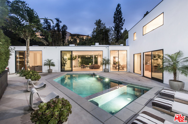 Completely rebuilt + reimagined from the ground up, this Mid Century Modern checks every box. Located in prime Holmby Hills, set behind a lush, Brazilian-inspired canopy of bamboo + meticulously landscaped greenery lies an ultra-private Modern Architectural masterpiece completely secluded from the street + enclosed in walls of glass. Flow from the open kitchen or the expansive open living area through 12-ft retractable doors leading to the sun-drenched backyard + brand new pool. 3 guest rooms with en-suite baths + walk-in closets make way to one of the most impressive master suites in LA. Boasting ~5,000 sqft. of living space, 4 beds/6 baths, chef's kitchen, full bar, 12-ft ceilings + vast entertaining spaces - Other features include Crestron Smart Home + Security system, custom woodwork/stone finishes, retail-grade closets, Miele appliances + Waterworks fixtures throughout. One of the highest quality homes on the market, in the most exclusive neighborhood in Los Angeles.