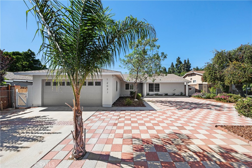 Welcome to this beautifully maintained single-story home in the heart of Lake View Terrace. As you arrive, you’re greeted by an expansive, low-maintenance landscaped front yard, enclosed by a covered porch that boasts curb appeal. Inside, natural light fills the open floor plan, featuring a spacious living room with recessed lighting and a stylish brick fireplace that seamlessly flows into the dining area—perfect for gatherings. The brand-new custom chef’s kitchen is a true highlight, showcasing soft-close cabinetry, quartz countertops, stainless steel appliances, and direct access to the laundry room and garage for everyday convenience. The generously sized primary suite offers comfort and style with recessed lighting, sliding closet doors, and abundant natural light. Two additional bedrooms share a full hallway bathroom complete with a soaking tub/shower, vanity, custom tile, and elegant fixtures. Step outside to your private backyard retreat—an entertainer’s dream with a large covered patio, lush landscaping, and mature fruit trees. Additional features include newer dual-pane windows throughout the whole home, newer furnace and water heater, fresh interior and exterior paint, modern hardware and fixtures, and a separate storage room, etc. Ideally located just minutes from Hansen Dam Recreation Area, enjoy access to hiking trails, swimming pool with waterslides, large lake divided into a swimming area with walk in beach/recreation area for non-powered boating, sailing, and fishing, splash pad, sports courts and more! With the 210 freeway nearby, commuting is a breeze. Don’t miss this fantastic gem—schedule your private showing today!