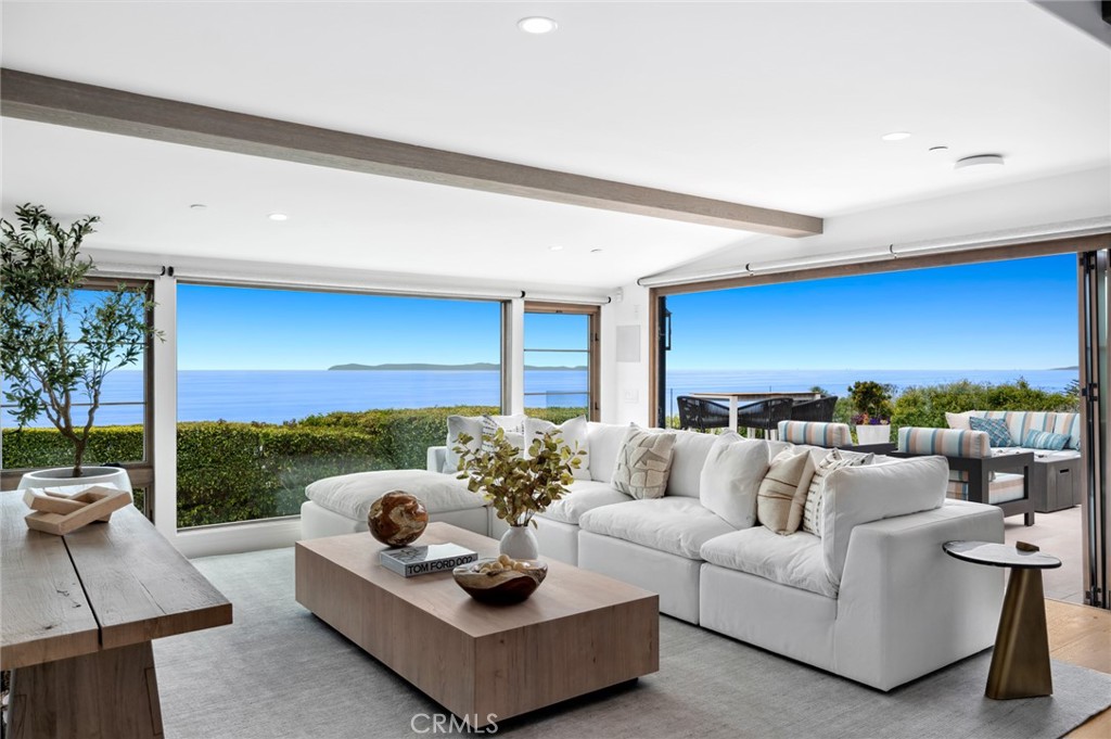 History meets modern luxury at this one-of-a-kind coastal retreat pool home in Laguna Beach with breathtaking ocean views, where an extensive complete renovation was completed in 2020. Offering unparalleled privacy and panoramic coastal vistas from every room, this estate sets a new standard for sophisticated coastal living. Spanning 180º of ocean, Catalina and sunset vistas from its setting at the end of a cul-de-sac that is an easy stroll to Victoria Beach and the Montage Resort. Christened Ciela del Mar–“Heaven of the Sea,” by the original owner/inventor in 1937, the property is meticulously designed and rebuilt with top quality while leaving an irreplaceable uniqueness in certain maintained historical enhancements. A living area defined by white oak beamed ceilings, a wood-burning fireplace and panoramic ocean vistas is the heart of the home. The main room opens to a large limestone patio with a saltwater pool and spa overlooking mesmerizing ocean vistas, all with complete privacy in an ambiance embellished with special lighting, multiple fountains and an outdoor shower. Discover bespoke amenities, including Paul Ferrante custom lighting, a Control4 smart-home system, integrated speakers, advanced security features, whole-house water purification, and custom alder wood doors and windows throughout with custom shades and draperies. An elevator connects all levels, ensuring effortless access throughout the home. Kitchen includes a Wolf range, Sub-Zero refrigerator, Miele dishwasher and quartzite countertops, while the dining room hosts a temperature-controlled wine cellar and opens seamlessly to a protected patio via a full-wall glass pocket door. Enjoy hosting outdoor dinner parties with heaters, an enchanting original stone fireplace, beautiful plantings and a jasmine trellis creating the ideal atmosphere. Perfectly arranged, the floor plan lives like a single-story design with a secondary primary suite and an office on the main level. The top floor reveals a private primary retreat with lofty ceilings, ocean views and a fireplace. The primary bath shines with marble finishes, a luxurious ocean-view steam shower, and a large walk in closet. An attached two-car garage with ample guest parking will make all feel welcome. This meticulously designed home is just moments away from restaurants, galleries, resorts and Laguna Beach's village. Schedule your private tour today and embrace this truly unique property representing the pinnacle of coastal living.