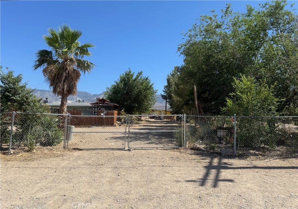 Escape to the serenity of Lucerne Valley with this charming 2-bedroom, 2-bath home nestled on 1.25 acres. This desert retreat offers mature trees for privacy, a rose garden, and a fully fenced lot with a private well, perfect for peaceful living or hobby farming, multiple storage sheds, a detached 1-car garage/workshop, and a carport. Enjoy wide-open mountain views, landscaped areas, and simple desert living just a short drive from town. A rare opportunity to own a versatile, self-sustained home with both charm and potential.