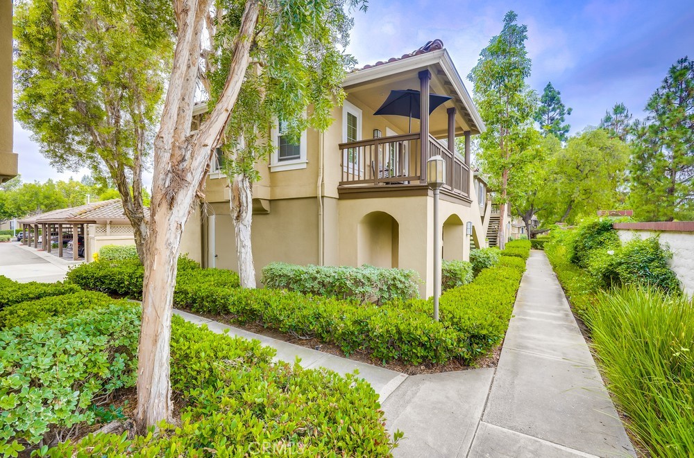 253 Gallery Way is beautifully perched among the trees on a corner location in this so-desired Shadow Canyon community. Privacy abounds with no one above or below. Open and inviting single level spacious floor plan with entry living room & the adjoining dining room. The upgraded gourmet kitchen is a chef's delight for lavish dining or casual faire. This home features expansive windows throughout. 2 bedrooms, 2 upgraded bathrooms, inside laundry area, an expansive front deck and all on one level too! Enjoy the luxury of newer double-paned windows, top-quality carpet, high-end window blinds, recessed lighting, gorgeous fireplace and more. The attached garage below has been freshly painted and has new epoxy flooring. An additional assigned carport is also included. You will absolutely delight in this resort-style community with swimming pools, a kiddy pool, BBQ & picnic areas, fitness center, a playground, tennis court and the clubhouse too. All this and near Tustin Ranch Golf Club, the Tustin Sports Park, Heritage Park, shopping and dining at Tustin Market Place and close proximity to freeways and toll roads. Also nearby is the spectacular Performing Arts Center, world-class shopping at South Coast Plaza, miles of sparkling bays, sandy beaches and crashing waves in Newport Beach! You will want this one now!
