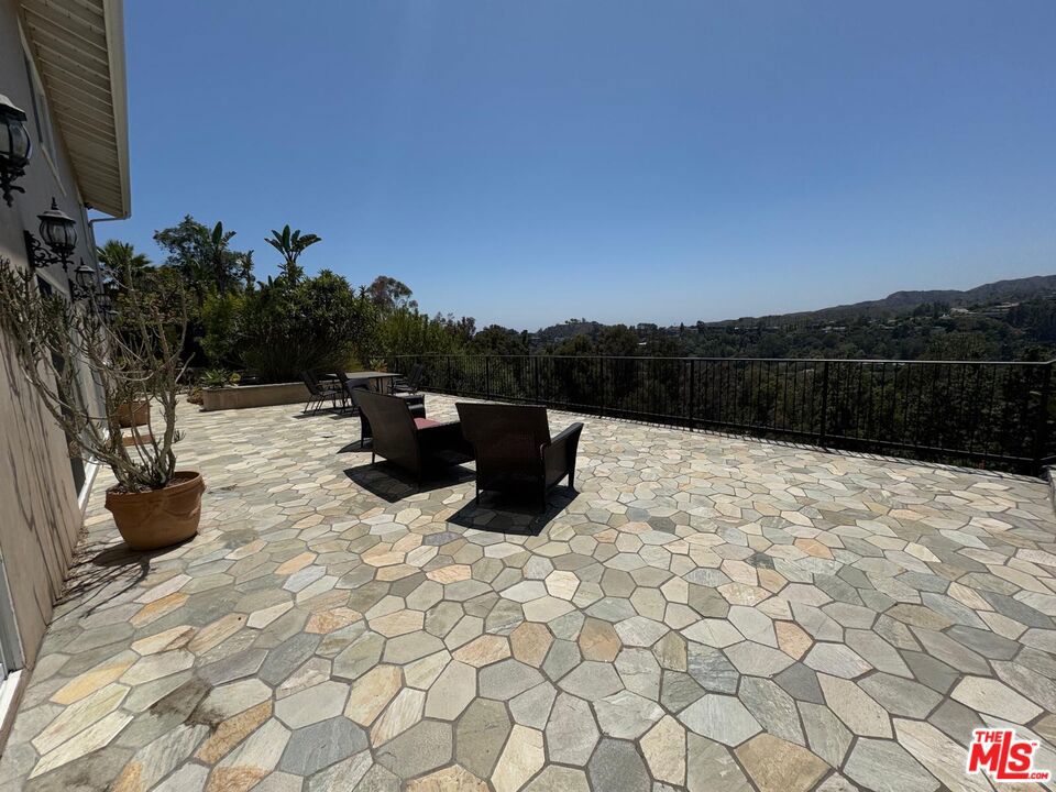 Brentwood Mountaintop Home with Breathtaking Views! Discover a quiet and luxurious lifestyle in this exquisite two-story contemporary home. Nestled on a tranquil mountaintop in Brentwood, this residence offers breathtaking panoramic views of Mandeville Canyon. The home features four bedrooms and an office/den, providing ample space for both living and working. Enjoy year-round comfort with two central A/C and heating systems. For your convenience, some furniture can stay, making your move-in seamless. With its serene location and stunning vistas, this home is an ideal sanctuary. Easy to show.