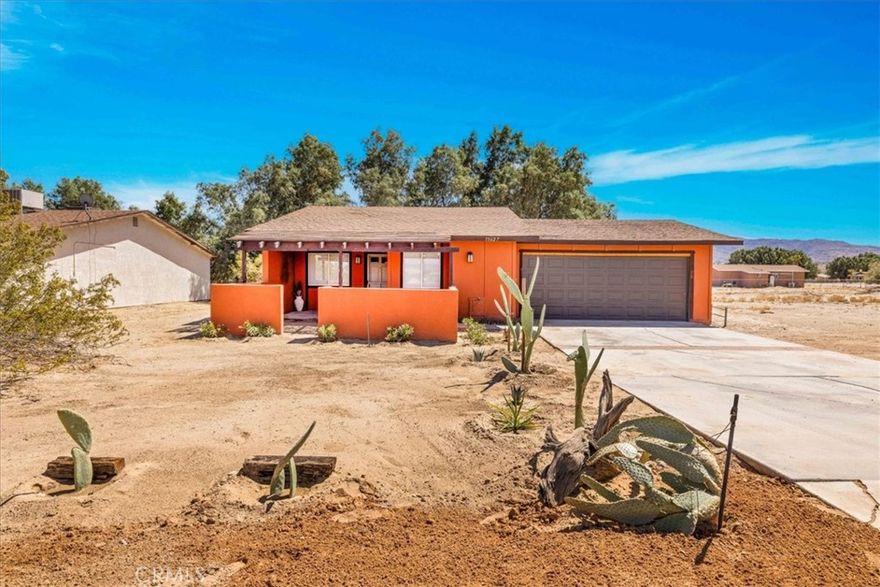 Welcome to this charming and beautifully remodeled 2-bedroom, 2-bathroom home in 29 Palms! This 978 sq. ft. gem is painted a rich burgundy hue, blending perfectly with the desert landscape to create a cozy adobe-style aesthetic. Ideally located near the Marine Base, this home sits on a 7,400 sq. ft. lot, with the added bonus of an empty lot next door for extra space and privacy. Tucked behind Smith’s Ranch Drive-In Movie Theatre, you'll have no rear neighbors, giving you a peaceful and open feel. Inside, enjoy the fresh upgrades, including new countertops, stylish flooring, and central AC/heat to keep you comfortable year-round. Washer and dryer hook-ups conveniently located in the insulated oversized two car garage. Situated just minutes from downtown 29 Palms and the stunning Joshua Tree National Park, this home offers both convenience and charm in an unbeatable location. A true must-see!