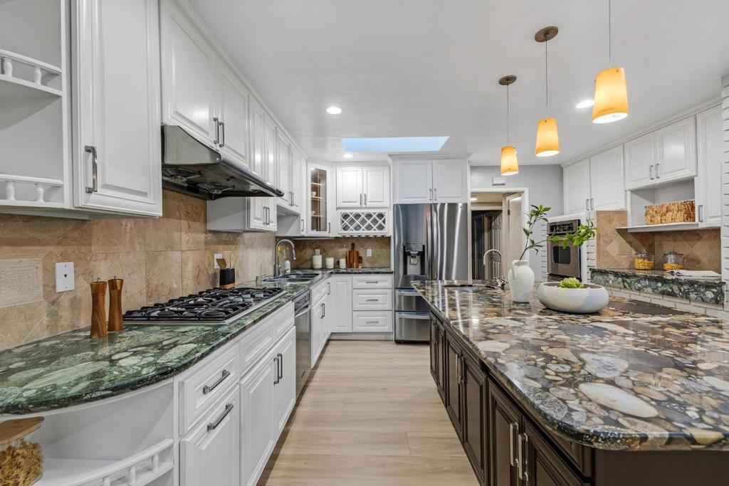 Welcome to this beautifully upgraded Cupertino gem featuring a spacious main home and a separate income-generating rental unit! The main residence offers approx. 2,582 sqf with two primary suites, two additional bedrooms, an office with a built-in bookshelves, and multiple living areas including a formal living room, family room, and formal dining room. The bright gourmet kitchen features granite countertops, a central island, skylight, gas stove, double ovens and stainless steel appliances. Recent upgrades include new flooring, fresh interior/exterior/garage painting, updated bathrooms with new vanities, mirrors, lights, and shower doors. Enjoy a newly landscaped backyard with a covered patio roof, perfect for entertaining, new concrete walkways and side yard , and a durable metal roof. The ~1,000 SQF 2BR/1BA rental unit has a private entrance, its own address, and a one-car garage ideal for guests, in-laws, or rental income. Prime near near top-rated Cupertino schools, parks, Deep Cliff Golf Course, Blackberry Farm, trails of McClellan Ranch Preserves, Apple HQ, major Hi-Tech companies, easy access to 280/85. This home offers the perfect balance of nature, recreation and convenience! DON'T MISS THE OPPORTUNITY TO OWN A PROPERTY OF EXCEPTIONAL VALUE IN SILICON VALLEY.