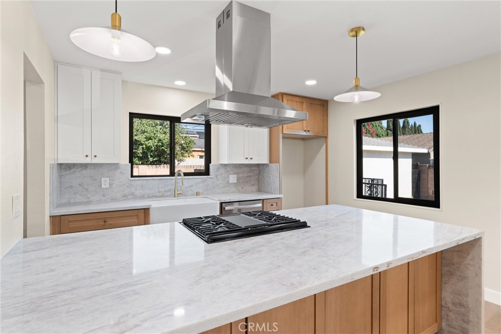 Introducing 13562 Springdale Street. This stunning single-story residence has been completely reimagined from top to bottom, offering 3 bedrooms, 2 bathrooms, and 1,309 sq. ft. of beautifully designed living space on a 6,500 sq. ft. lot.
The home welcomes you with brand-new luxury vinyl plank flooring and an open concept layout filled with natural light. The chef’s kitchen showcases custom white oak soft-close cabinetry, Taj Majal quartzite countertops with a striking waterfall edge, and all-new stainless steel appliances. The living room is anchored by a cozy fireplace, creating the perfect space to gather.
Both bathrooms have been fully remodeled with designer tile work, quartz counters, and spa-inspired finishes, including a walk-in shower and dual vanities in the primary suite. Every detail has been carefully considered, from the new dual-pane windows throughout to the modern lighting and fixtures.
A detached two-car garage sits at the rear of the property, and the expansive lot offers endless potential. There is plenty of space for a pool, an outdoor oasis, or an ADU to accommodate multigenerational living or additional rental income.
Located in the highly desirable Indian Village neighborhood of Westminster, this home blends modern luxury with everyday convenience, offering easy access to schools, shopping, dining, and freeway connections. Move-in ready and designed for today’s lifestyle, this is a rare opportunity not to be missed.