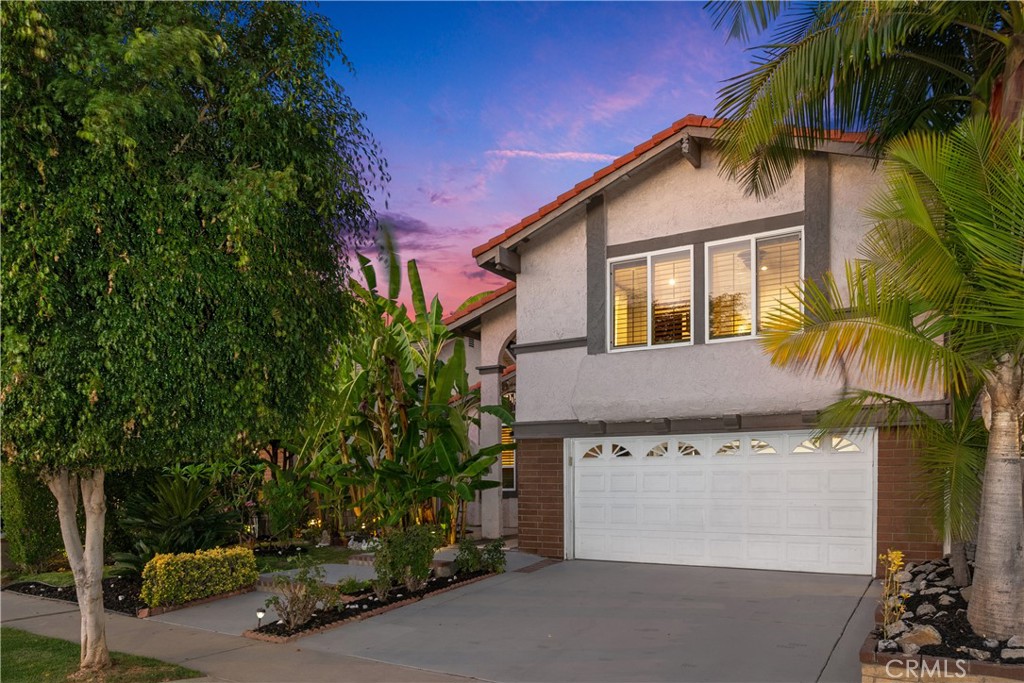This enchanting two-story single-family home boasts four spacious bedrooms and two and a half bathrooms, ideal for comfortable living and entertaining. You’ll be captivated by the stunning front yard, offering a picturesque setting that enhances the home’s curb appeal. Enter inside to discover a warm and inviting den and family room where memories are waiting to be made, making the layout flow seamlessly, providing ample space for relaxation and gatherings with loved ones. The true gem of this home lies in its backyard oasis where tranquility awaits. Enjoy your own personal retreat with a serene pond, charming gazebo, and a cozy fire pit, perfect for entertaining or relaxing under the stars. The garden is a paradise with a variety of fruit trees, including guava, papaya, avocado, curry leaves, sugar apple, tangerines along with fresh mint for your culinary delights. With a convenient two-car garage and located within the highly regarded ABC School District, this home is surrounded by excellent schools, beautiful parks, and shopping centers, making it ideal for those who enjoy convenience. Plus, you’ll appreciate the convenient access to the 5 and 91 freeways for commuting and exploring the greater area. This home truly combines charm, comfort, and functionality. Don’t miss your chance to make this beautiful home your own!