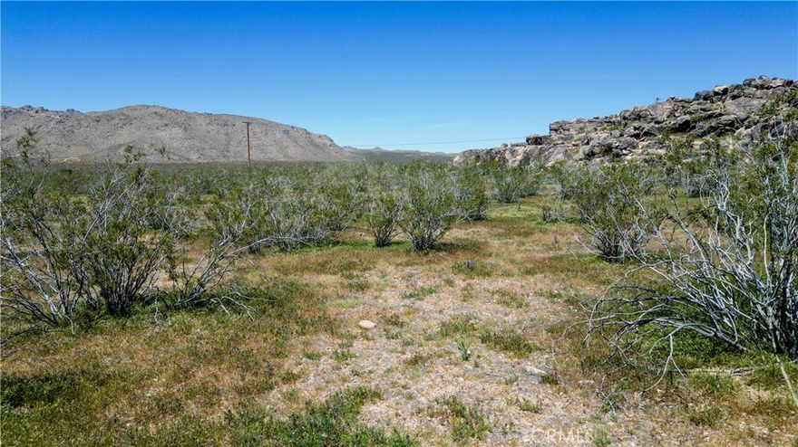 Opportunity awaits on this 2.37-acre parcel in Apple Valley's high desert, positioned for the upcoming Brightline West high-speed rail connecting to Las Vegas by 2028. The gently sloping terrain offers excellent drainage with typical desert shrub vegetation and scattered rock outcroppings providing natural privacy. Power lines run approximately 350 feet from the property boundary, while cable and phone services are available in the area, making utility connections feasible for development. The lot features moderate elevation changes ideal for custom home placement with potential mountain views. Road access exists via assessor maps though the connecting route from Keator Road requires establishment. Residential zoning allows single-family development with space for outbuildings, RV parking, and recreational activities. The High Desert location provides 283 sunny days annually, minimal light pollution for stargazing, and proximity to Mojave Narrows Regional Park, Deep Creek Hot Springs, and extensive hiking trails. Apple Valley's strategic position in the growing Inland Empire corridor, combined with the transformational rail infrastructure investment, positions this raw land for appreciation. Property is well-suited for buyers seeking privacy, space, and development flexibility in an area experiencing infrastructure-driven growth. Coordinates 34.53977, -117.1 place you minutes from Highway 18 and major desert recreation areas. Ideal for off-grid living, future development, or land investment. Cash buyers preferred given utility connection requirements and remote access considerations.