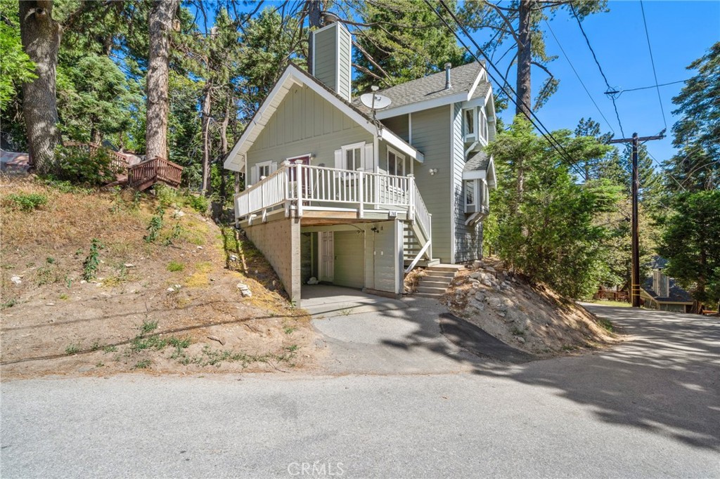 Welcome to 746 W. Victoria Ct, a charming 2-bedroom(primary suite is very large), 2-Bath cabin nestled in the scenic Lake Arrowhead Villas community. Originally built in 1932 and thoughtfully remodeled in 2006. This Cozy 861 sq ft home sits on a spacious 4,000 sqft lot. Bonus room that's off of family room with cozy window bench and additional storage closet that you can let your imagination run wild and use it as a kids play room, reading library, home office or storage for all your toys. Kitchen cabinets are solid wood and custom made, large storage room upstairs, Balcony off downstairs bedroom to use to enjoy the beautiful trees surrounding it. Large balcony off front of home with gorgeous picturesque views of mountains. well maintained engineered hardwood throughout downstairs. Comes with 1 covered carport that provides protection against the elements. There is also a designated laundry closet off carport. Your surrounded by majestic mountains, lush trees, and peaceful woods. whether you're an outdoor enthusiast or simply seeking a serene retreat, this property offers breathtaking views and easy access to hiking trails, mountain biking, winter skiing and countless other outdoor adventures. Experience the perfect blend of rustic charm and modern comfort in this beautiful Lake Arrowhead getaway!