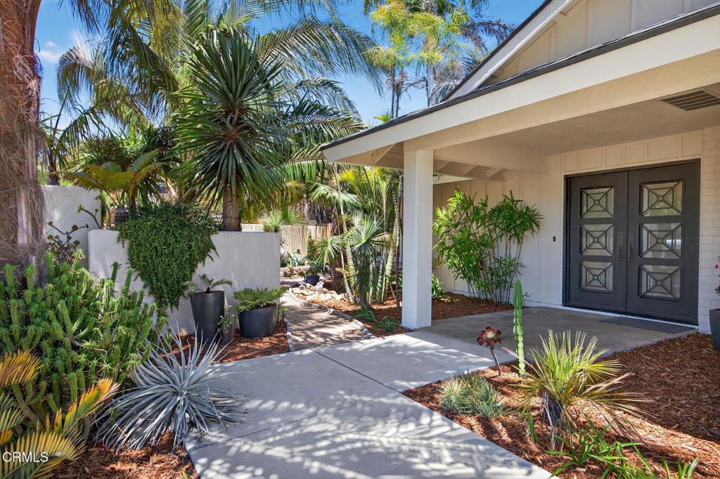 Private oasis in the heart of Ventura. Lush, native plantings surround this 4 bed/2.5 bath home tucked behind a stucco wall making the front yard as secluded as the back. Entry showcases custom, wrought iron double doors with operable privacy panels allowing natural sunlight and a cool breeze into the home through the decorative scrollwork. Kitchen taken down to the studs & expanded with custom, solid cherry cabinetry, center island, Corian counters, stainless appliances & an additional wall of cabinets for pantry items. Sliding doors open onto the patio and immense backyard. The sizeable primary bedroom suite has sliding doors to its own deck, en suite bath, and multiple closets. First floor bonus room & full bath offers options for an additional bedroom, office or playroom. Arroyo Grande Park, schools & shopping nearby.