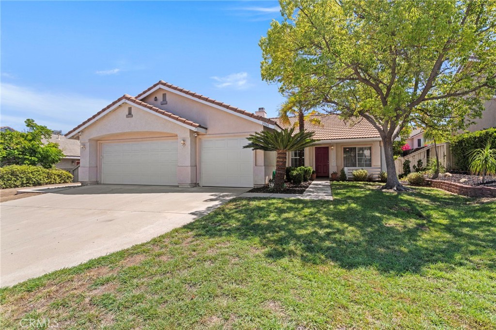 This well-maintained 3 bedroom, 2 bath home offers 1,428 sq ft of living space on a generously sized lot of nearly 8,000 sq ft. Inside, you'll find beautiful wood flooring throughout, granite countertops in the kitchen, and stainless steel appliances. The home also features a 3-car garage, perfect for parking, storage or hobbies. The backyard is a great size for relaxing, entertaining, or gardening. Conveniently located in a quiet, established neighborhood close to schools, minutes from lake, shopping, and with easy access to the 15 Freeway. Low taxes and no HOA make this home a great opportunity at a great price point.