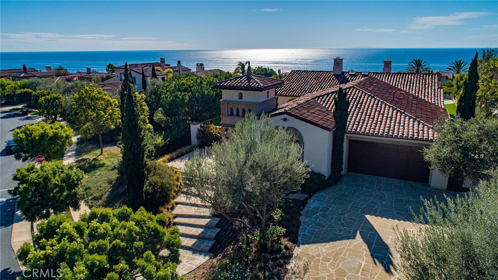 Indulge in the essence of resort-style living at this exquisite single-level ocean view estate in the prestigious, guard-gated community of Crystal Cove. Elevated on a private 14,779 sq ft lot, this refreshed 4 bedroom, 4.5 bath residence blends timeless sophistication with casual coastal elegance.
A gated front courtyard welcomes you to the property, where a charming detached casita offers an ideal retreat for guests. Inside, sun-drenched living spaces feature an inviting blend of formal and informal rooms designed for both everyday comfort and refined entertaining. The gourmet kitchen is a chef’s delight, appointed with a Wolf range oven, Sub-Zero and Viking appliances, and Calacatta Oro marble countertops with hand-distressed edges. The spacious owner’s suite, privately situated at the rear of the home, opens through French doors to the backyard oasis and showcases a spa-like bath and ample closet space. Three additional en-suite bedrooms, including the casita, provide exceptional flexibility for family, guests, or office use.
Step outside to an entertainer’s paradise, complete with a saltwater pool and spa, outdoor fireplace under a covered loggia, teak decking, BBQ island, and manicured landscape—all set against a backdrop of sweeping coastline, Catalina Island, and whitewater views. As a resident of Crystal Cove, enjoy unmatched amenities including 24-hour guard-gated security with patrol, the Canyon Club with Jr. Olympic-sized pool, spa, fitness center, tennis and basketball courts, and numerous social and recreational programs. Private access leads directly to Crystal Cove State Park and beach, while world-class shopping, dining, and entertainment at Fashion Island, Laguna Beach, and Corona del Mar are just moments away. Or just take a short stroll down the hill to visit the Crystal Cove Shopping Center, were fine dining and shopping awaits. Available for annual lease, unfurnished, 64 Archipelago offers an unparalleled opportunity to experience coastal California living at its finest.