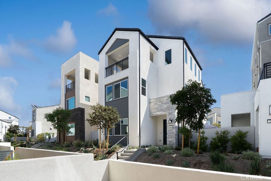 This brand-new three-story detached condominium features a contemporary floor plan with ample space for future expansion. The open-concept layout on the ground floor seamlessly integrates the kitchen with the living and dining areas. At the same time, a bedroom and full bathroom are conveniently located at the residence's rear. You'll find three additional bedrooms, including the luxurious owner’s suite upstairs. A flexible bonus room is situated on the third floor, complemented by a private outdoor deck. Solar energy systems are included. Skye at Rise is part of Irvine's Great Park Neighborhoods master-planned community. This vibrant community offers a wealth of amenities such as a swimming pool, parks, playgrounds, a community center, dog park, picnic areas, splash park, tot lot, sports courts, volleyball courts, greenbelts, and walking trails. The Irvine Spectrum, a popular shopping and entertainment hub featuring numerous dining options, the Irvine Improv, and a Regal movie theater, is nearby. Convenient access to the I-5 and I-405 freeways ensures easy commuting.