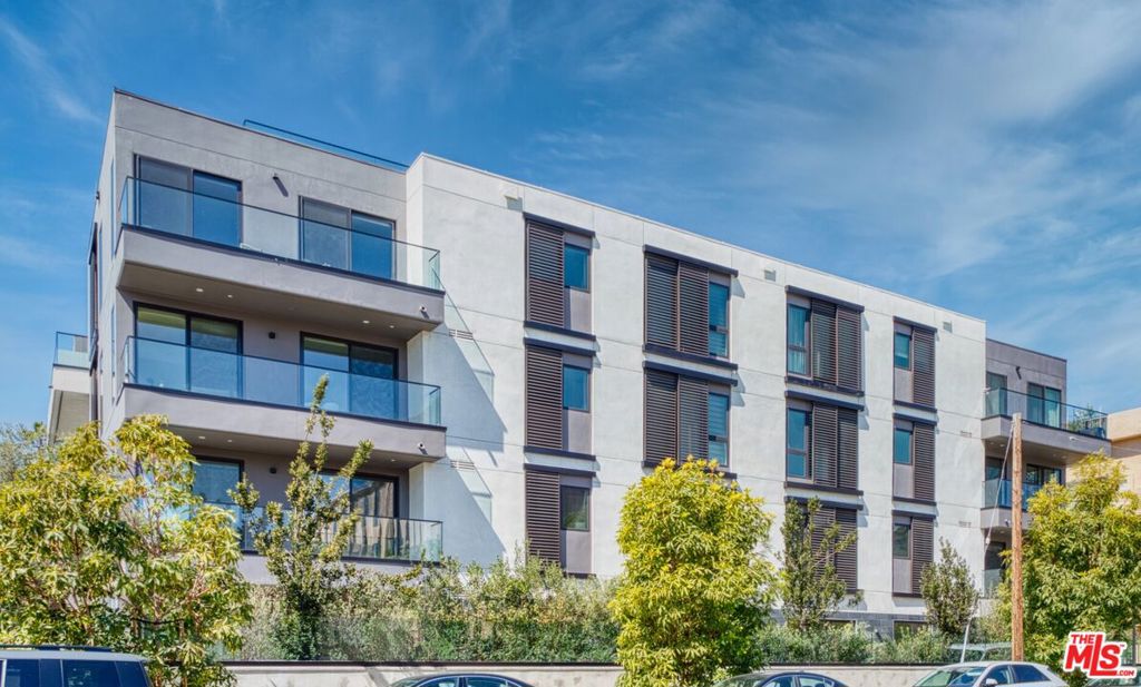 Experience upscale living in this 1-bedroom, 1-bath residence at Delyla Condos, ideally situated in the heart of Beverly Grove. Spanning 1,198 sq. ft., this stylish home features an open-concept layout and a spacious north-facing balcony, perfect for enjoying a private, shaded outdoor escape. The thoughtfully designed interior boasts wide-plank hardwood floors, marbled Caesarstone countertops, and sleek Italian cabinetry. The gourmet kitchen is equipped with premium appliances, including a paneled Sub-Zero refrigerator and dishwasher, a Wolf induction cooktop with oven, a 36" hood, and an expansive wrap-around island ideal for entertaining. The spa-inspired bathroom showcases polished gray tile slab showers, Emser porcelain flooring, Duravit sinks, and elegant Gessi fixtures. Throughout the home, LED recessed lighting enhances the modern aesthetic. Residents of Delyla enjoy resort-style amenities such as a concierge, fitness center, resident lounge, outdoor entertaining area with a pizza oven, and secured subterranean parking. Located just moments from the premier dining, shopping, and nightlife of Robertson Blvd, and close to Cedars-Sinai and key West LA destinations, this home presents a rare opportunity to own a sophisticated retreat in one of Los Angeles' most coveted neighborhoods.
