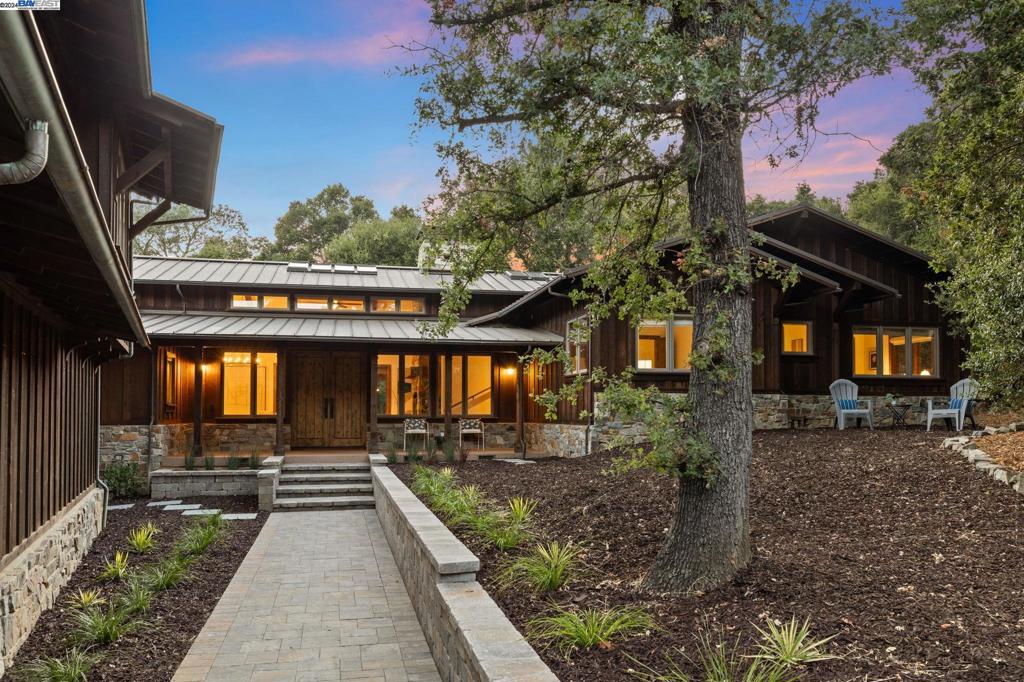 Nestled among the oaks in Central Portola Valley, this stylish 5-bed, 3.5-bath home and charming 1-bed, 1-bath ADU sit on a 1-acre lot. Upon entering, you are welcomed by 16-foot vaulted ceilings, a custom stone fireplace, and French doors leading to one of three back decks. Throughout the home, enjoy abundant natural light and hand-scraped hickory floors. The chef’s kitchen features a designer range, top-of-the-line stainless steel appliances, counter seating, and a dining area. The adjacent family room, with its own stone fireplace, allows for seamless entertaining and comfortable everyday living. The primary suite includes a cedar-lined walk-in closet, large en-suite bathroom, and patio access. Three additional bedrooms plus an office provide versatile living. A finished basement offers a multi-use gym, home theater, kids' space, or office. Outside, the low-maintenance yard and playhouse are ready for kids and adults to enjoy. Above the 3-car garage, a spacious 750 sq. ft. ADU includes washer/dryer, kitchen, and AC for comfort and convenience. Enjoy community and natural beauty with a short walk to Windy Hill Open Space Preserve, Portola Valley Town Center, shops, and trails. Excellent PV schools and easy access to Highway 280 complete this exceptional property.
