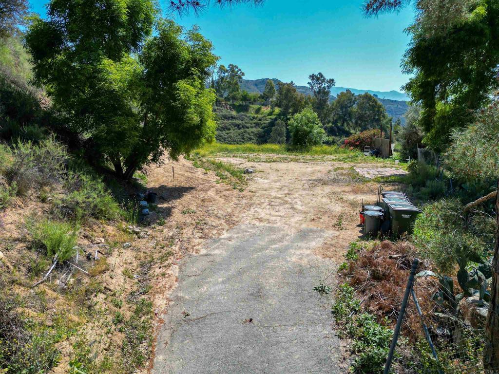 Stunning 16-acre parcel located in Rainbow Heights with panoramic views, rolling topography, and four rough-graded pads ready for your custom home or agricultural project. Enjoy cool evening breezes in a peaceful valley setting, perfect for a vineyard, grove, or hobby farm. Great sun exposure, natural beauty, and privacy—just minutes from Hwy 76 and I-15. Utilities nearby, water meter connected, no HOA. Septic layout on file. Manufactured homes allowed.