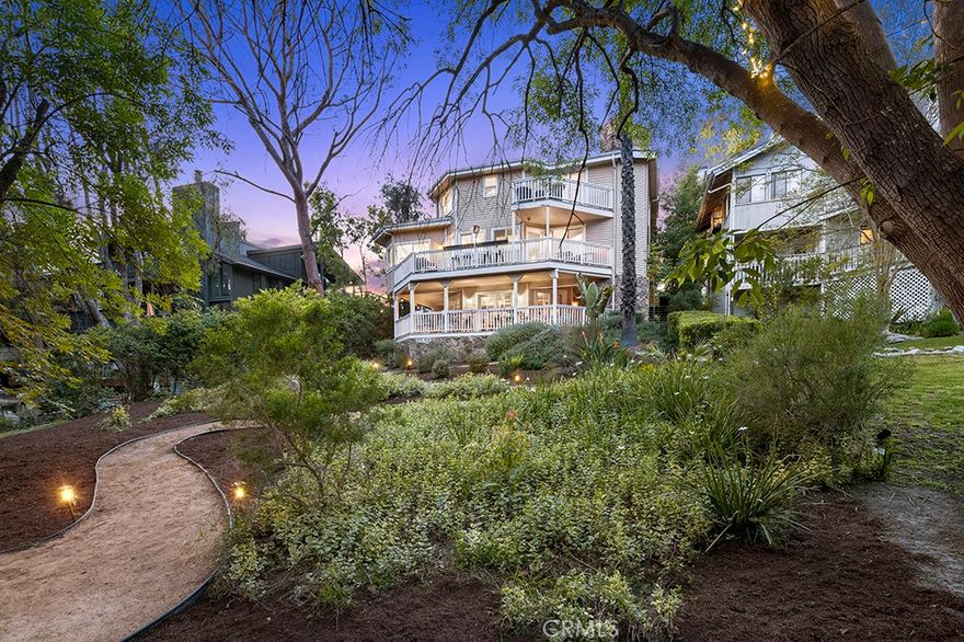 Set amidst the enchanting landscape of Coto de Caza’s coveted Village enclave, this exquisitely remodeled residence is a rare blend of refined design and serene natural beauty. Surrounded by lush foliage and soaring trees, this home offers unparalleled privacy and gorgeous views from nearly every room. A storybook-style entry porch invites you to unwind in style—perfect for evening cocktails, relaxed conversation and soaking in the warm hues of twilight as day turns to dusk. The heart of the home is a show-stopping kitchen appointed with custom shaker cabinetry, striking quartz countertops, a generous center island with bar seating and premium stainless steel appliances—designed to inspire both everyday living and elevated entertaining. The entry level showcases a thoughtfully designed layout with a dedicated office, sophisticated powder room, spacious laundry room and direct access to an oversized two-car garage. The master suite is a sanctuary unto itself, featuring a spa-caliber bath with a stunning standalone soaking tub, an expansive walk-in shower, and beautiful quartz countertops that evoke understated luxury. Three generously sized secondary bedrooms and a well-appointed bathroom complete the upper level. On the ground level a versatile bonus room provides endless possibilities for a media retreat or gym and connects directly to a private guest bedroom and bathroom. Every level of the home seamlessly integrates indoor and outdoor living with expansive decks that invite you to unwind while taking in serene vistas of the sprawling backyard and majestic trees beyond. Whether you're dining al fresco, hosting guests, or enjoying quiet moments, the connection to nature is ever-present. Offering the perfect blend of luxury and comfort, this distinctive Village residence invites you to experience the essence of elevated Coto de Caza living. Don’t miss this remarkable Village residence—where architectural charm meets modern sophistication, and every day feels like a retreat.