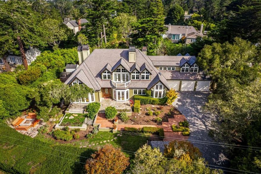 Offering a wonderful combination of English Manor architectural influences with modern day features and amenities, this elegant yet cozy ocean and Pt Lobos view Central Estate area home offers spacious rooms, high ceilings, tall windows and an abundance of South and West facing light. Set behind a stately gated entrance accompanied by lush mature hedging all around, privacy abounds whether looking in or looking out. Strolling through the English garden on the way to the front door, the aroma of roses and fresh citrus will follow you in where formal entry, living and dining rooms give way to the spacious gathering room in which kitchen, family room and informal dining act like one. A generous size main level suite and an Architectural Digest worthy library, both with double French doors to the outside, complete the downstairs before heading up where three ocean view suites reside. Overly generous in size the primary suite challenges you to fill not one but two oversized walk-in closets with extra storage on the side. Drawing you outside, there are cozy places and spaces to enjoy with patios, firepit and an outdoor kitchen where your choice of grand entertaining and peaceful moments can be had. Aesthetically pleasing, generous in space and volume a great estate to have.