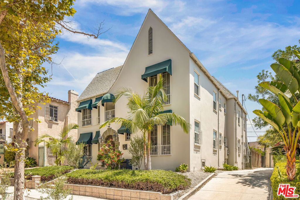 A striking example of 1930s Los Angeles architecture, this character-rich duplex in Hancock Park pairs period detailing that feels both timeless and cinematic. Recently refreshed with a new roof, HVAC unit, exterior paint, and landscaping, the building presents a classic facade framed by mature greenery and windows crowned with stylish deep green awnings. Each of the full-floor residences offer 3-bedrooms, 2-full bathrooms, and generous proportions throughout. Upon entering, hardwood floors add warmth, while a sculptural Batchelder fireplace brings quiet drama to the living space. Sunlight moves through paned windows and archways, pulling you through the formal dining room into a spacious kitchen outfitted with a breakfast nook and a separate laundry room with outdoor access. Ample storage, with multiple closets and built-ins discreetly integrated throughout. Out back, a detached three-car garage and additional storage offer utility, while updated landscaping frames the property. Set on a tree-lined stretch of Sycamore Avenue, moments from the new Wilshire/La Brea Metro Station, The Grove, LACMA, and the city's most coveted cultural and culinary landmarks, 842 S Sycamore is an investment in both beauty and versatility.