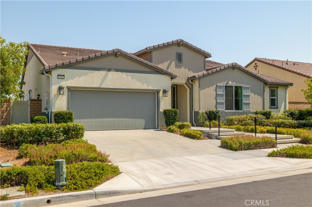 Located on a premium lot in the highly desirable master-planned community of Audie Murphy Ranch, this former model turnkey home boasts over $350,000 in designer upgrades. Thoughtfully designed with luxury finishes and flexible living spaces, this home truly has it all. A dramatic entryway leads into a spacious open-concept great room, ideal for entertaining and everyday living. The gourmet kitchen features rich “Burlap” maple cabinetry, quartz countertops, satin nickel hardware, custom full-tile backsplash, and GE Monogram appliances including a 36” dual fuel range with professional hood. An extended center island, under-cabinet lighting, a prep kitchen with additional cabinetry, and a built-in beverage center complete this impressive culinary space. The elegant primary suite offers a spa-like retreat with a custom-tiled super shower with ceramic surround, dual vanities, and a large walk-in closet. 2 of the additional 3 bedrooms share a Hollywood-style bathroom, with each bedroom having its own vanity and walk-in closet for added privacy and convenience. A generously sized formal dining room provides versatility and can easily serve as a game room, media room, or bonus living space. It overlooks a charming covered courtyard—perfect for indoor-outdoor flow. Off the kitchen, a flex room offers an ideal spot for a home office, study nook, or craft area. Upgrades include 8-foot interior doors, tile flooring in main living areas, plush carpet in the bedrooms, recessed LED lighting, designer pendant lights over the kitchen island, and ceiling fans in all bedrooms and the covered rear patio. Energy-efficient features include paid solar, helping to reduce utility costs and increase sustainability. Tesla car charger installed in garage.