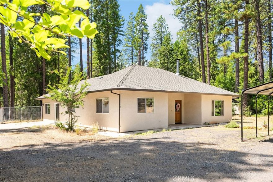 Tucked away on a peaceful cul-de-sac in scenic Forest Ranch, this charming 4 bedroom, 2-bathroom, PLUS office home sits on just over an acre of beautifully landscaped land, surrounded by majestic pines and vibrant gardens. With a thoughtfully designed split floor plan, soaring 9’ ceilings, and engineered wood flooring throughout, this home offers both comfort and style.



The spacious primary suite is privately located apart from the other bedrooms, with direct access to a serene open patio—perfect for morning coffee or evening stargazing. The large laundry room offers abundant storage, and a free-standing wood stove adds cozy charm for those crisp mountain nights. Quality built with 2x6 exterior framing and a whole house fan, the home is made for year-round efficiency.



Step outside to enjoy the fully fenced backyard, lush with three types of grapevines, blackberry bushes, and two producing apple trees, an Asian pear and peach tree and a full bed of lemon balm. Raised garden beds are ready for your green thumb, while the expansive back yard includes an irrigation system on the fruit trees. Multiple outbuildings and room for RV parking give you all the space you need for hobbies and storage. The seller has also built an incredible custom, handmade spa made out of cedarwood and powered by propane. 



Enjoy peaceful evenings in the enclosed, screened-in patio or observe the local deer, rabbits, and squirrels that frequently visit—nature lovers will feel right at home.  Whether you’re dreaming of a quiet retreat, space to garden, or room to roam, this property checks all the boxes. Come see it today—your new beginning awaits!