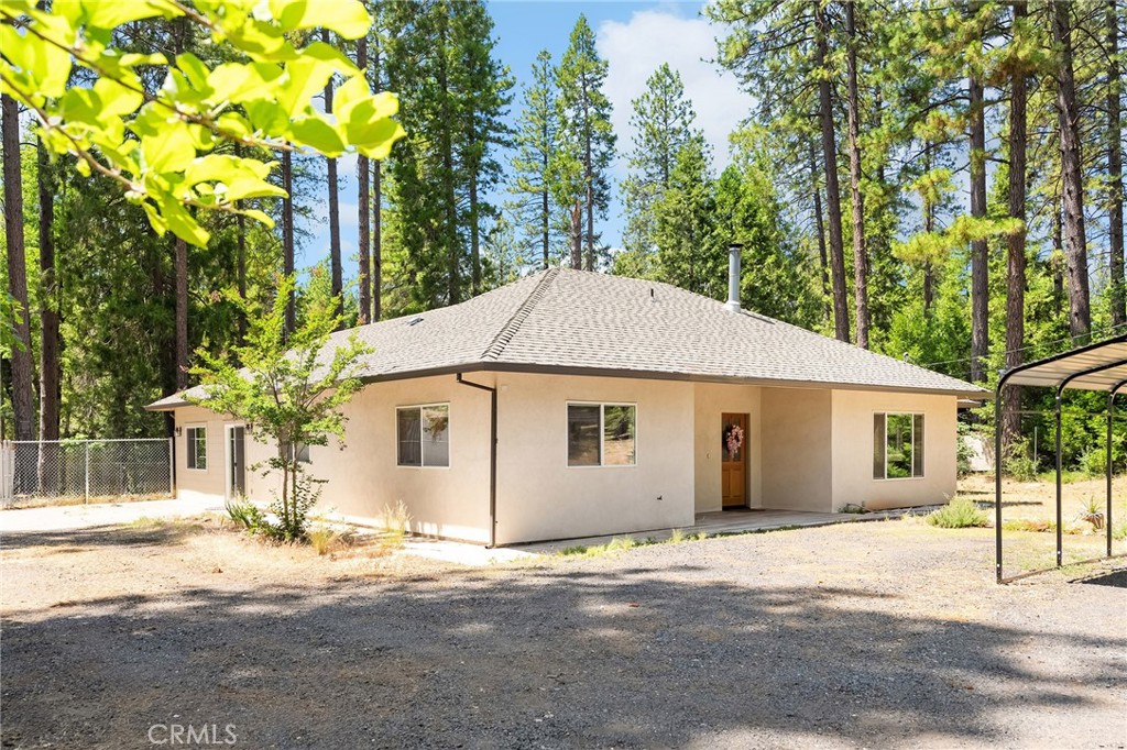 Tucked away on a peaceful cul-de-sac in scenic Forest Ranch, just 20 minutes from Chico and a mile from Forest Ranch Charter School, this charming 4 bedroom, 2-bathroom, PLUS office home sits on just over an acre of beautifully landscaped land, surrounded by majestic pines and vibrant gardens. With a thoughtfully designed split floor plan, soaring 9’ ceilings, and engineered wood flooring throughout, this home offers both comfort and style.
The spacious primary suite is privately located apart from the other bedrooms, with direct access to a serene open patio—perfect for morning coffee or evening stargazing. The large laundry room offers abundant storage, and a free-standing wood stove adds cozy charm for those crisp mountain nights. Quality built with 2x6 exterior framing and a whole house fan, the home is made for year-round efficiency.
Step outside to enjoy the fully fenced backyard, lush with three types of grapevines, blackberry bushes, and two producing apple trees, an Asian pear and peach tree and a full bed of lemon balm. Raised garden beds are ready for your green thumb, while the expansive back yard includes an irrigation system on the fruit trees. Multiple outbuildings and room for RV parking give you all the space you need for hobbies and storage. The seller has also built an incredible custom, handmade spa made out of cedarwood and powered by propane.
Enjoy peaceful evenings in the enclosed, screened-in patio or observe the local deer, rabbits, and squirrels that frequently visit—nature lovers will feel right at home. Whether you’re dreaming of a quiet retreat, space to garden, or room to roam, this property checks all the boxes. Come see it today—your new beginning awaits!