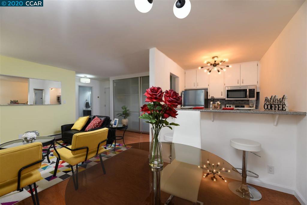 This beautiful 1 bedroom, 1 bathroom condominium is located on a quiet street in the desirable Adams Point neighborhood of Oakland. This light & airy unit has an open concept living space, with an updated kitchen, breakfast bar, & a living room with a large private deck that is great for relaxation and entertaining. The living room has warm accent walls, & contemporary lighting. Tasteful upgrades throughout include granite counters, designer brushed nickel faucets, tile flooring, manufactured hard wood floors, & all new stainless steel appliances. The bedroom is spacious & you can’t miss the abundance of closets throughout. The bathroom includes a contemporary floating vanity, LED anti-fog mirror, & crystal vanity lights. This wonderfully quiet unit is perfectly situated close to Lake Merritt, popular restaurants, cafes, bakeries, Trader Joe’s, Whole Foods, & the famous Grand Lake Theater. Commute options abound: Close to 19th Street BART Station, Casual Carpool, & easy freeway access.