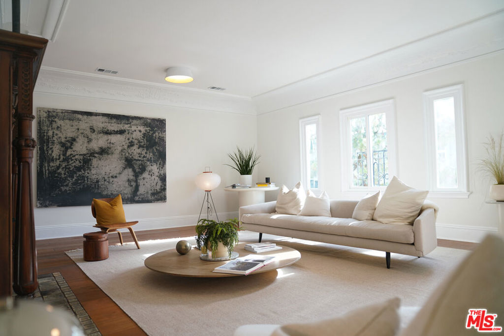 THE KINGSLEY COLLECTION: Where Timeless Elegance Meets Modern Luxury. Step into a piece of Los Angeles history, beautifully reimagined for today's discerning homeowner. The Kingsley Collection presents exquisitely restored in 2025, four individually titled residences within a landmark 1920s Italian Renaissance Revival building. UNIT 324 is the second-floor residence, thoughtfully designed to provide the perfect balance of privacy, natural light, and treetop views. With approximately 2,400 SF of refined living space, it captures the charm of a single-family home while delivering the ease of low-maintenance living. Meticulously renovated, the home seamlessly marries its rich architectural heritage with contemporary sophistication. Admire the preserved elegance of floral Queen Anne crown molding in the formal living and dining rooms, and be captivated by the original handcrafted Batch elder fireplace tiles--a signature of California's early 20th-century artistic craftsmanship. The inviting living room flows effortlessly into the dining area, which opens to a private balcony, your serene spot for al fresco dining or a quiet morning coffee among the trees. The gourmet chef's kitchen is a culinary dream, featuring natural quartz counter tops, custom wood cabinetry, elegant brass hardware, and top-of-the-line Viking appliances. The sunlit primary suite is a true retreat, complete with dual closets, a built-in vanity, and a spa-inspired bathroom featuring a luxurious marble shower and a classic soaking tub. Guests will appreciate the equally stylish secondary bedroom with its own full bath, finished with the same high-end appointments. Enjoy the added convenience of a dedicated laundry room and the ease of two dedicated tandem parking spaces. Nestled in a prime location, The Kingsley Collection places you at the center of LA's finest offerings. Indulge in the culinary delights of nearby Larchmont Village, explore the beauty of Hancock Park, experience the vibrancy of West Hollywood, and easily access the energy of DTLA. Everything you desire is just moments away. Don't miss this extraordinary opportunity to acquire a truly unique and architecturally significant residence in the heart of Koreatown's historic neighborhood. Here, the grace of the past harmonizes perfectly with the luxuries of modern living. Welcome home to The Kingsley Collection.