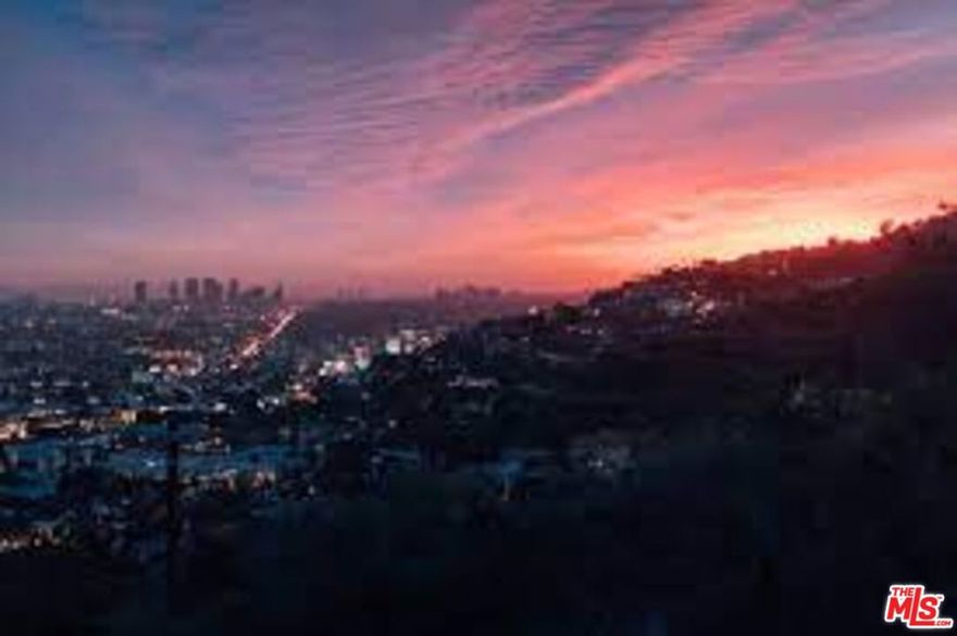 A quintessential California contemporary with unobstructed sunrise-to-sunset views, this entirely reimagined and rebuilt residence is a private retreat designed for tranquil enjoyment and sublime entertaining. Awash in light, the home sits above a protected greenbelt held by the Santa Monica Mountains Conservancy. The open plan interior, with cathedral ceilings, museum lighting, spacious gallery walls, and handsome wide-plank, oil-finished European oak floors, flows seamlessly to the outdoor living area, with its custom knife-edge pool and spa, outdoor kitchen, fire pit, large grassy yard and generous terraces. Every finish, fixture and detail has been selected and crafted for quality and bespoke sophistication. A home of impeccable design on a very desirable Laurel Hills cul-de-sac, this rare property embodies harmonious living at its very finest.