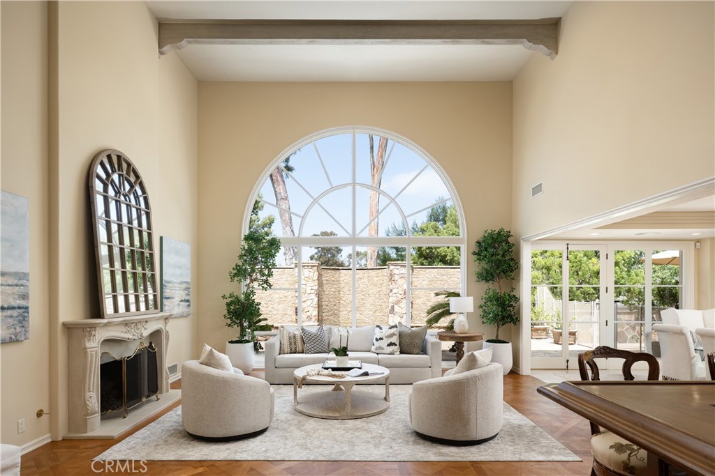 Set along the 4th fairway of the prestigious Big Canyon Country Club golf course, this elegant 5,400-square-foot residence offers the perfect balance of privacy, comfort and an entertainer’s lifestyle. Located within Big Canyon’s exclusive 24-hour guard-gated community the home sits on an oversized 11,250-square-foot lot with serene views of the 3rd hole. This beautiful two-story property feels more like a single level home, with the primary suite, a spacious home office, and all main living areas on the first floor.
A welcoming entry leads to luxurious formal living and dining rooms, each with soaring ceilings and abundant natural light. The heart of the home is the expansive, remodeled kitchen outfitted with premium Dacor appliances, freshly painted cabinetry and new window treatments, all flowing seamlessly into comfortable living spaces. A custom-built bar allows for even more opportunity to host gatherings both large and small in this one-of-a-kind home.
The main-floor primary bedroom suite is a serene retreat, offering peaceful views, a spa-inspired bath and ample walk-in closets. Upstairs, three additional bedroom suites provide plenty of space and privacy for family and guests.
The lushly landscaped backyard is a private haven designed for relaxation and fun, featuring a jacuzzi, tranquil waterfall, putting green, and multiple areas for outdoor dining and lounging. The extensive covered patio allows for outdoor enjoyment year round, taking advantage of the beautiful southern California climate.
Additional highlights include a recently expanded garage with room for three cars as well as golf cart parking and extensive storage. Also featured is a convenient inside laundry room, recently refreshed interior paint, e-pipe plumbing, an improved roof, a new tankless water heater, heat pumps, and more. This exceptional Big Canyon home blends timeless elegance with thoughtful updates, perfect for those who value both comfort and style.