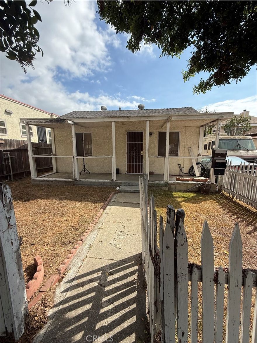 Front home offers 2 bedrooms, 1 bath, and an open kitchen flowing into the family room, with parking for up to four cars. The rear home includes 2 bedrooms, 1 bath, an attached garage, a large fenced yard, and additional parking. This property is a fixer being sold as-is, presenting excellent value-add and investment potential.