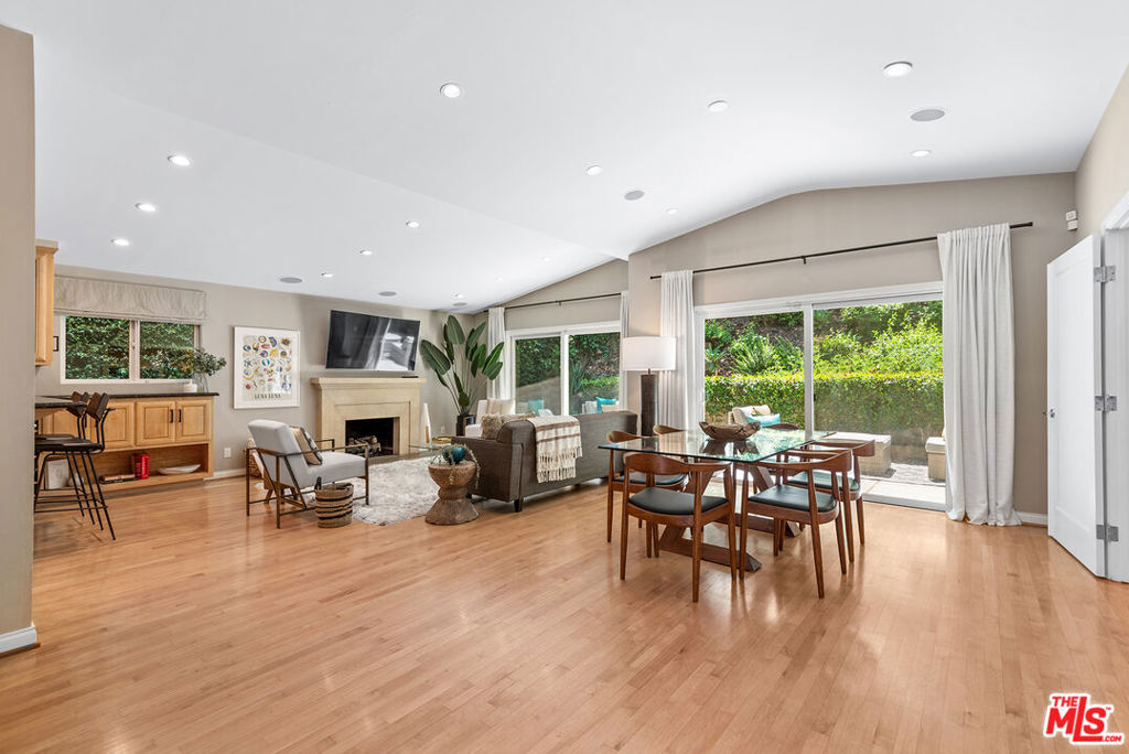 Thoughtfully renovated and versatile 2-bedroom, 2-bathroom single family retreat and a great condo alternative, nestled in the exclusive Beverly Hills Post Office neighborhood, moments from Beverly Hills. Step inside to enjoy pitched ceilings, rich hardwood floors, and sun-drenched living spaces that flow to a private backyard oasis. Designed for both entertaining and everyday living, the open-concept layout includes a chef's kitchen with Wolf range, Sub-Zero glass-door refrigerator, granite countertops, and sleek cabinetry. A built-in surround sound system sets the tone for hosting or unwinding. The primary suite is a true sanctuary, complete with a lux en-suite bath featuring dual sinks and spa-like steam shower. The second bedroom and bathroom are equally well-appointed, perfect for guests, a nursery, or a stylish home office. Out back, enjoy tranquil canyon vibes and lush greenery. The finished 2-car garage with a mini-split AC unit adds even more versatility: use it as a garage, home gym or office. Located in the coveted Warner Ave Elementary district, this home offers access to top-tier public schools and unmatched proximity to Beverly Hills' finest restaurants, shops, and amenities. This is California living at its best: stylish, serene, and perfectly situated. Don't miss this opportunity!