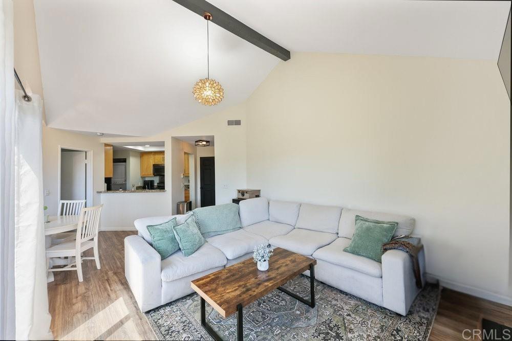 Located in the highly desirable Ranchwood Park Community of Spring Valley, this beautifully upgraded single-level condo features 2 private bedrooms with full bathrooms on opposite sides for ultimate privacy, a bright open living space with vaulted ceilings, exposed beams, a cozy fireplace, and an oversized balcony showcasing breathtaking 360° mountain views of the Sweetwater Mountains. The primary suite opens to the balcony, while the kitchen offers granite countertops, stainless steel appliances, and a convenient stackable washer/dryer inside the unit. Recent upgrades include a new water heater along with central A/C and heating. Enjoy resort-style community amenities including a year-round heated pool, spa, BBQ grills, tennis courts, dog park, and direct access to nearby hiking and walking trails. The condo also comes with a covered carport and enclosed storage. Perfectly located just minutes from Highway 94, the Sweetwater River Trail, Vineyard Hacienda, Edwards Cinema, and Hooleys Public House, with the exciting new Calavo Park expansion on the horizon offering sports fields, pickleball courts, a skate park, and more. HOA covers water and trash—this move-in ready condo truly has it all!