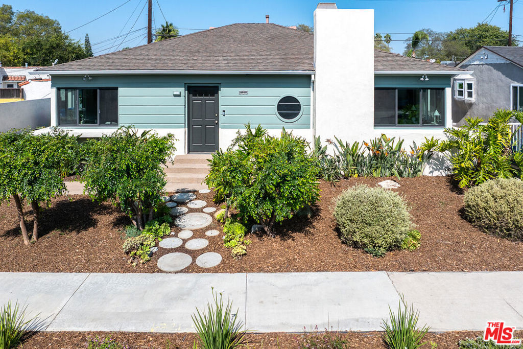 Thoughtfully renovated by its long-time owners, this rare Minimalist Modern home is a stunning blend of timeless architecture and contemporary comfort, nestled in the culturally rich and architecturally charming Leimert Park neighborhood. Bathed in natural light from morning to afternoon, the home welcomes you with an original archway leading to a spacious, inviting living room adorned with timeless architectural crown molding, a striking round porthole window, large picture windows, built-in shelving, and a classic fireplace, perfect for relaxing or entertaining. The well-designed floor plan flows seamlessly into a generous dining room and an updated kitchen featuring new appliances, custom finishes, and a one-of-a-kind, built-in circular breakfast nook, freshly upholstered for modern comfort. Additional upgrades and features include newer Milgard windows, custom window coverings, recently upgraded electrical panel, NEST controlled HVAC, recent duct work upgrades, fresh landscaping, hedged and private backyard, ample space for outdoor entertaining, and a two-car garage. Ideally located for convenience and lifestyle, this home offers quick access to major freeways, the Metro Line, and the new K Line to LAX, placing Downtown LA, the Westside, Silver Lake, Echo Park, and Pasadena all within easy reach. This is a rare opportunity to own a stylish, sun-filled home in one of Los Angeles' most iconic and centrally located neighborhoods.