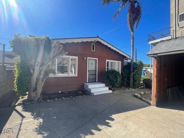 Charming 2-bedroom 1 bath cottage located just one block from Ventura's vibrant Main Street shops, restaurants and beaches! Open concept home with a large living room and dining room with gorgeous refinished original hardwood floors throughout. Wake up to sunlight streaming in through oversized windows throughout. Galley style kitchen with an indoor laundry area just steps away. Cozy brick fireplace for decoration only. There is even a rare partial basement for storage. The backyard area is a blank canvas to design and create your own oasis to unwind, perfect for morning coffee or evening gatherings. This cottage is nestled at the end of a private driveway of a multi-family unit. Don't miss your chance to live in one of Ventura's most sought-after neighborhoods, schedule a tour today!