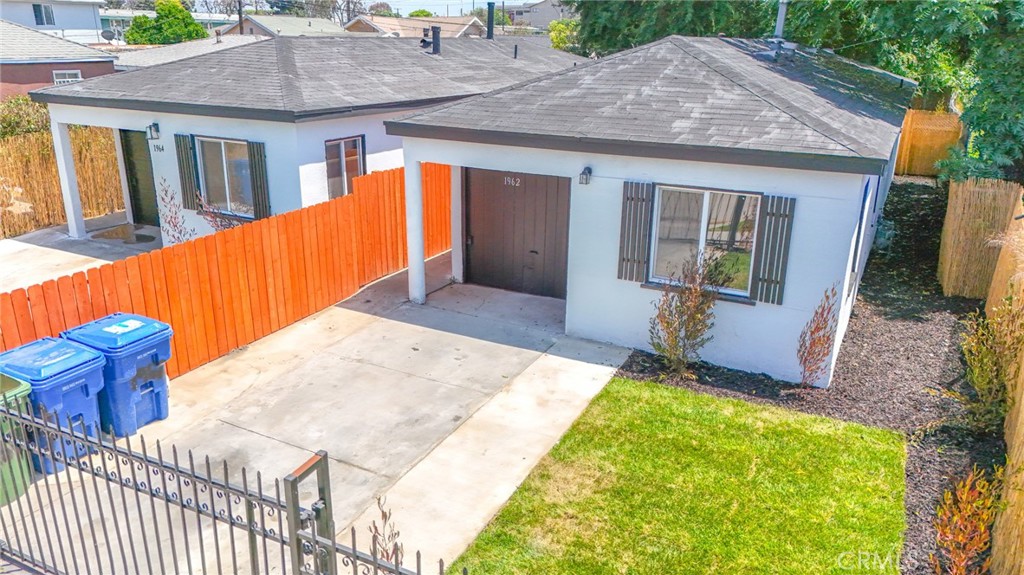 Move in ready... Features include: 2 Bedrooms / 2 Bathrooms + Partially Converted Garage with a Kitchenette, Beautiful kitchen with granite counter tops, updated bathrooms, Tile flooring in Living room, Kitchen, and Baths, New Carpet in Bedrooms. Uncovered driveway parking. Alarm on property, Freshly painted interior and exterior. This is a must see!
