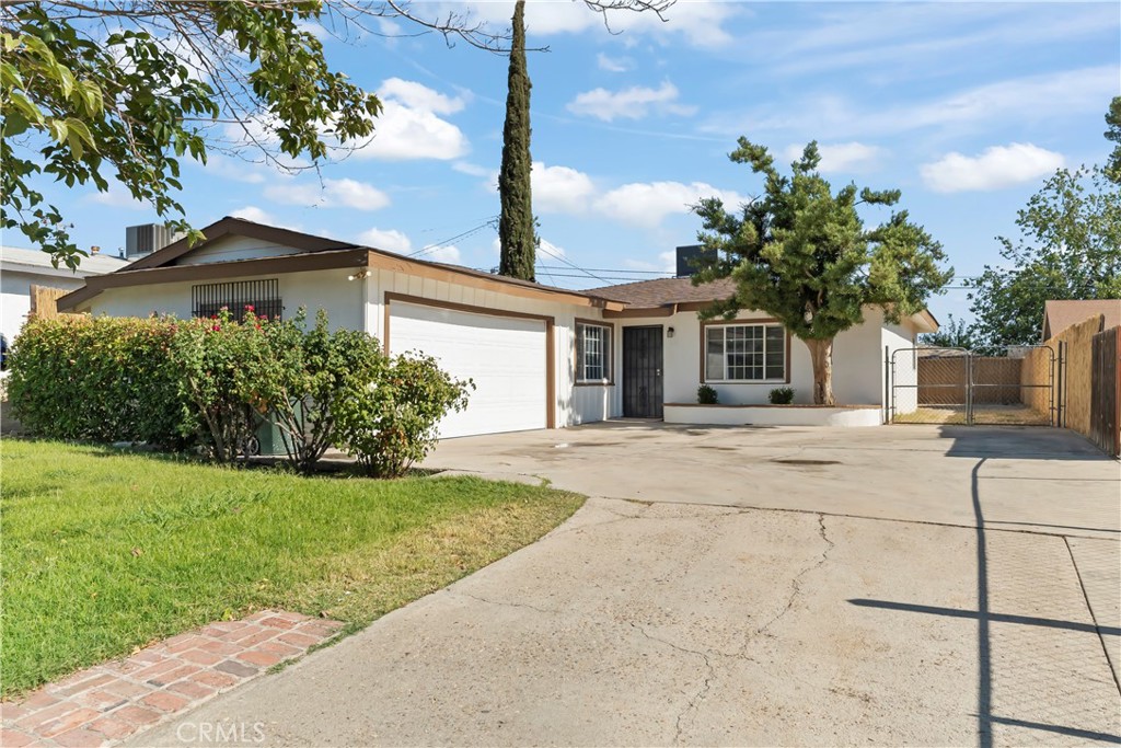 Step into this beautiful three-bedroom, one-bath home in North East Bakersfield! Featuring fresh interior paint, newer flooring, and updated kitchen, with a brand new countertop, this home is designed for both comfort and style. Upon entering the home, you'll find a cozy living room, and down the hall, three bedrooms and the bathroom, with a brand new vanity! Situated on a generous lot, the property includes a large driveway, beautiful front yard filled with greenery and roses, and very spacious backyard brimming with potential! Discover the perfect combination of charm and convenience in this inviting home!